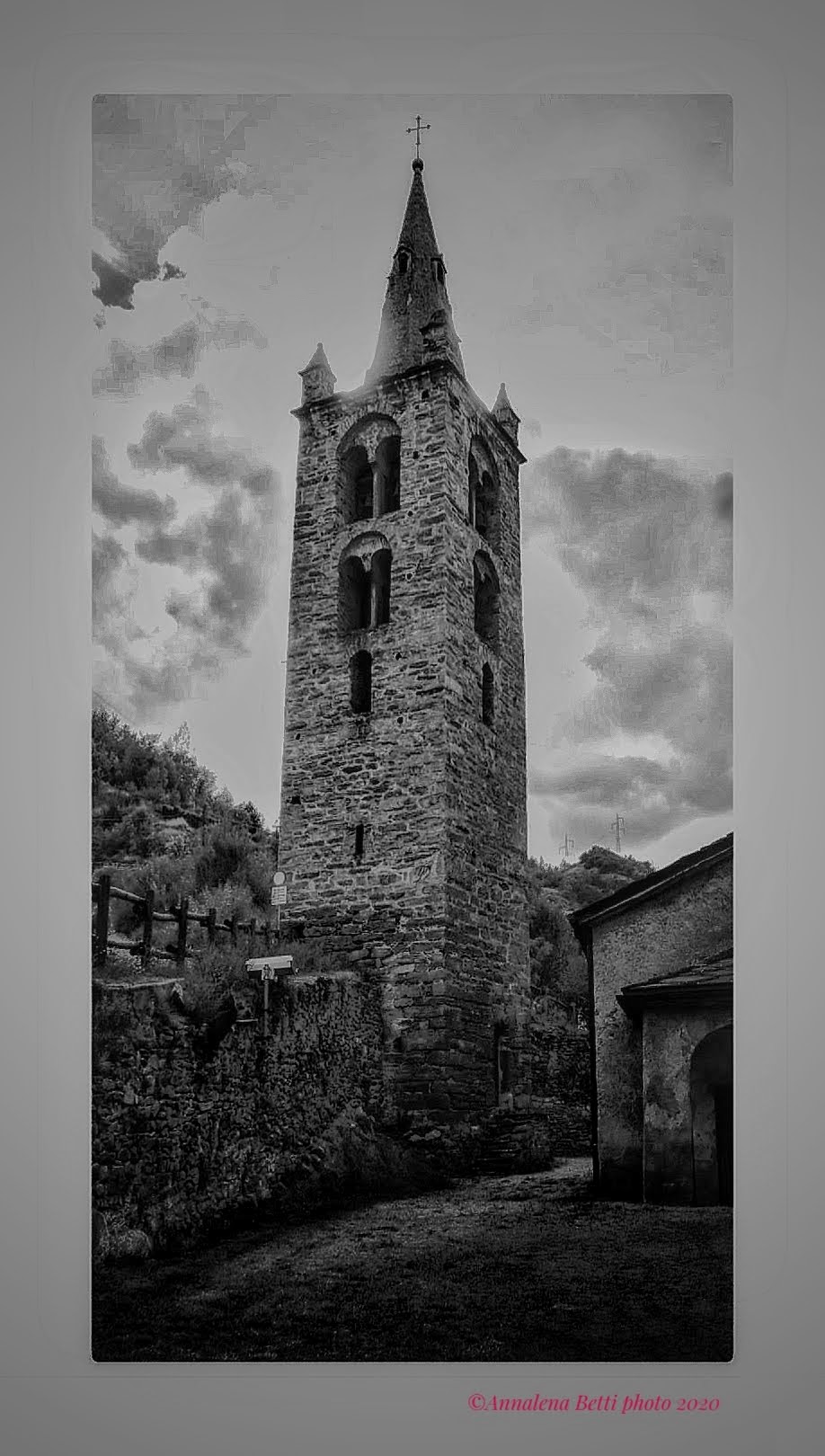 Strong backlight and burnt lights behind the bell tower