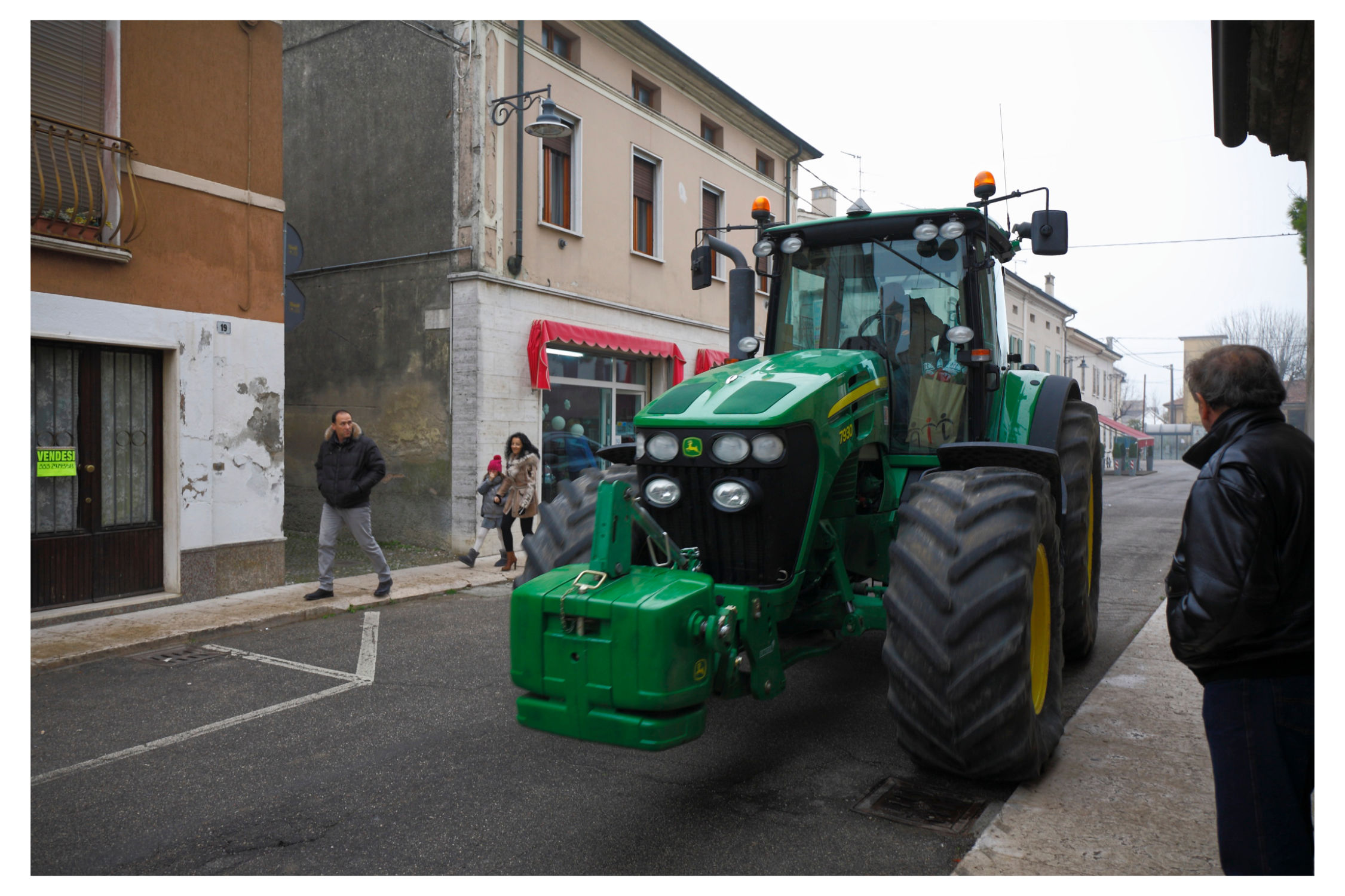 Agricultural tractors in the historic center of Piubega.