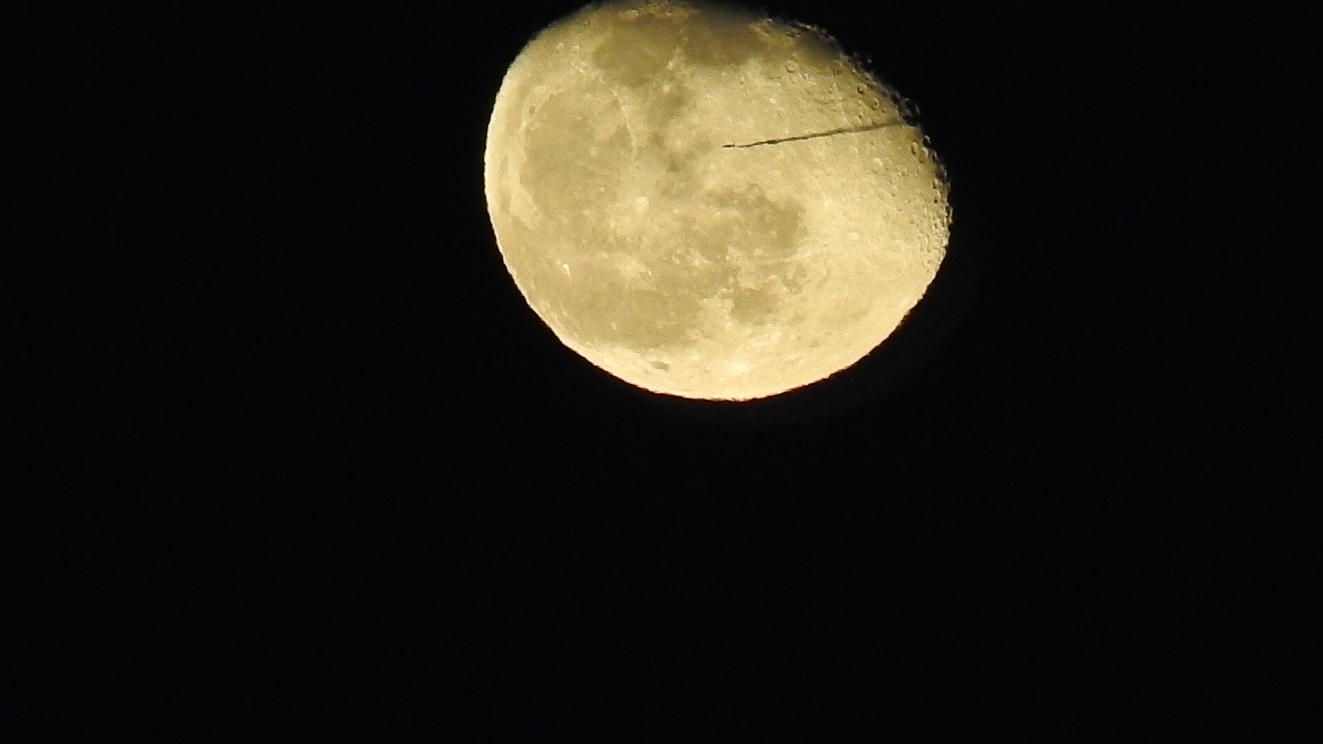 Plane passes into the moon.