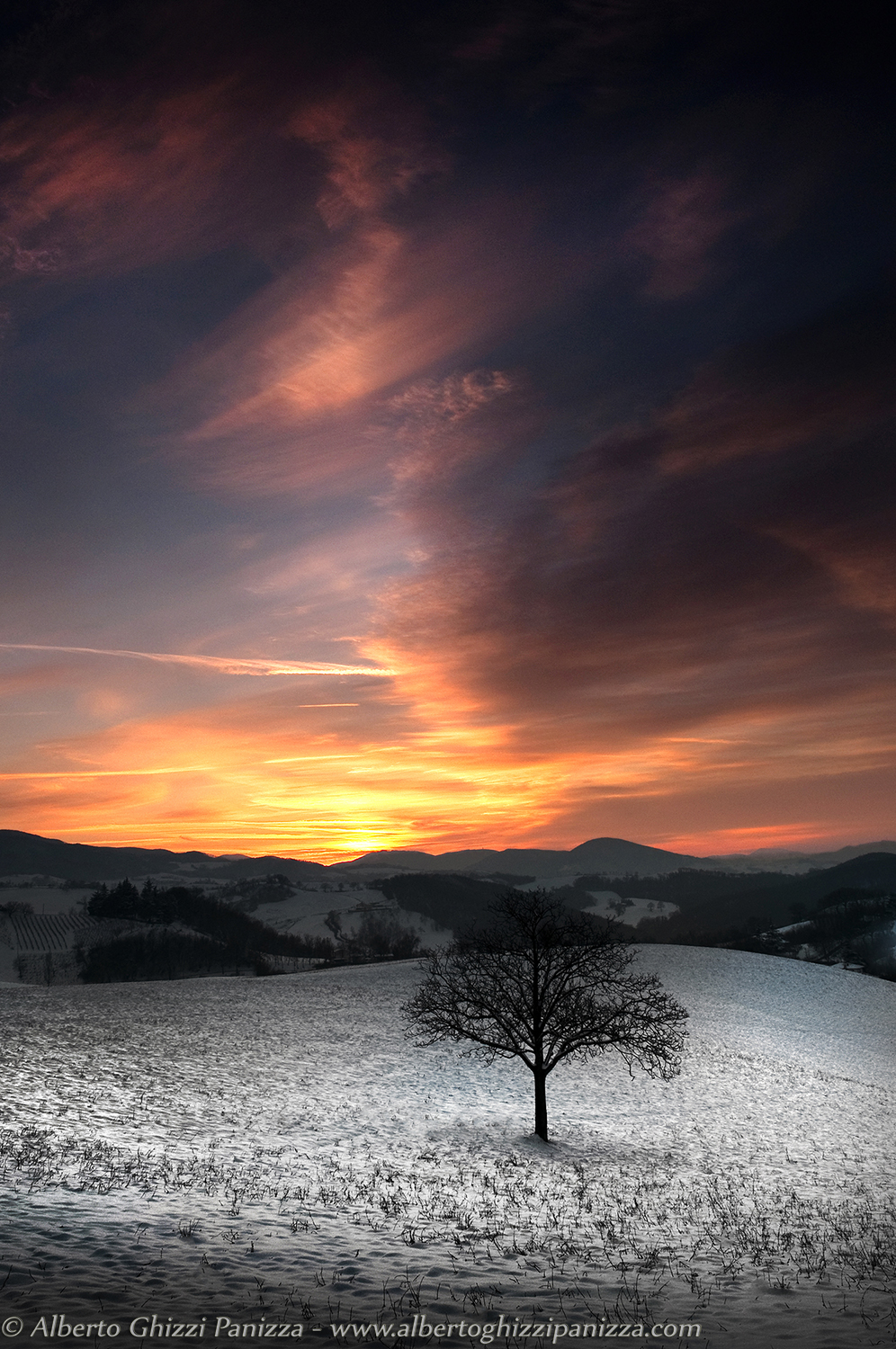 Sunset on snowy hill