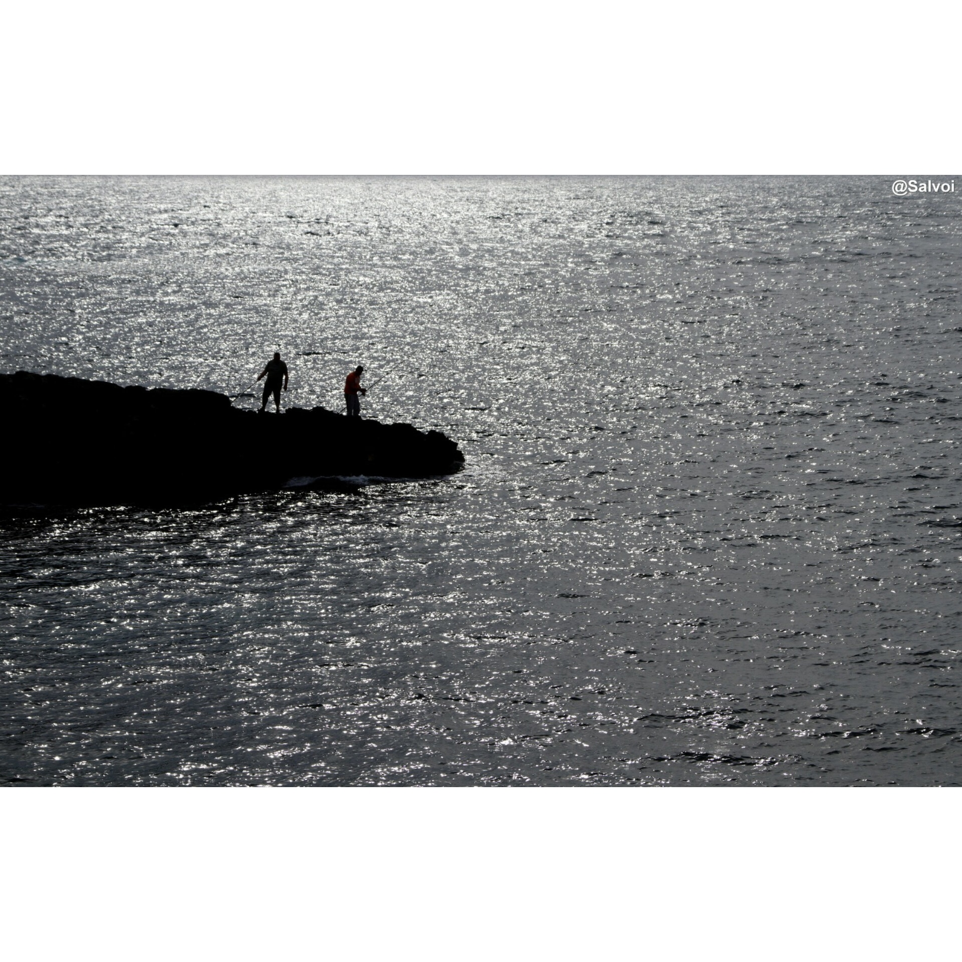 Fishermen against the light