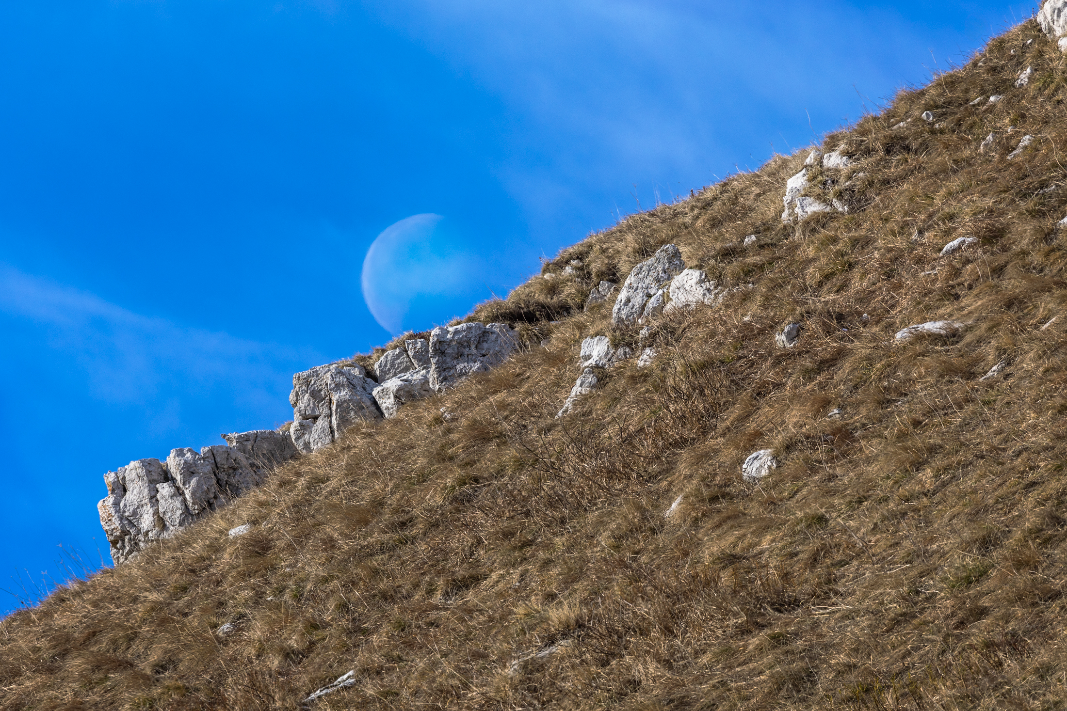The moon comes out of the mountain