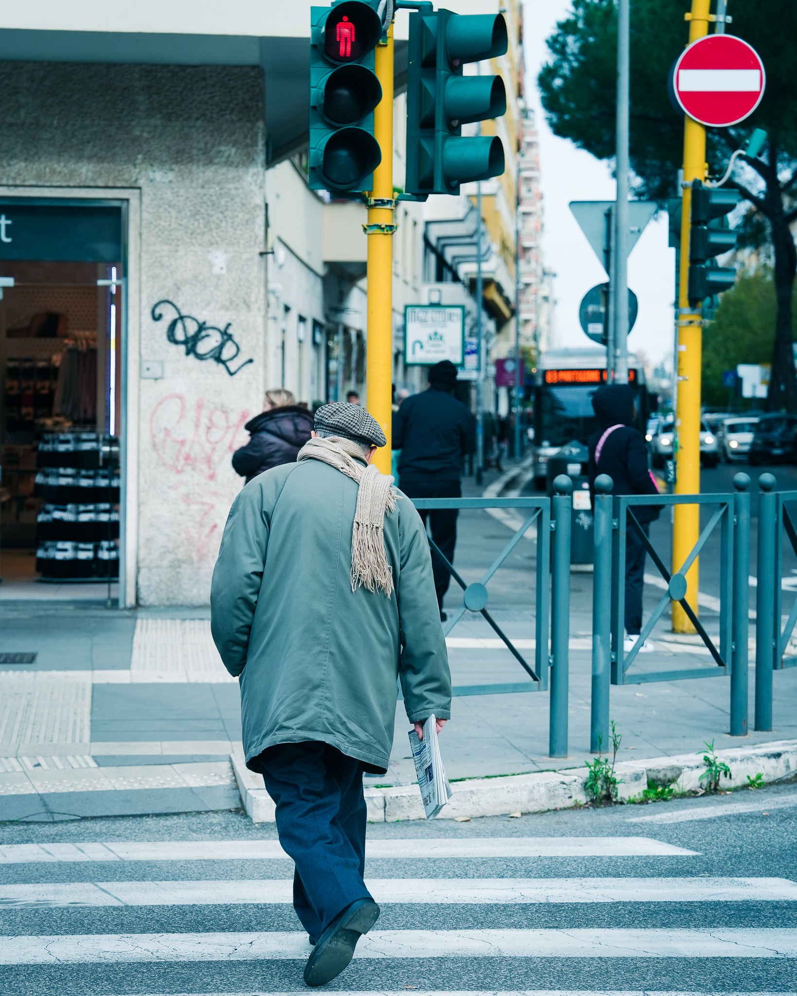 Street, man crossing pedestrian crossing