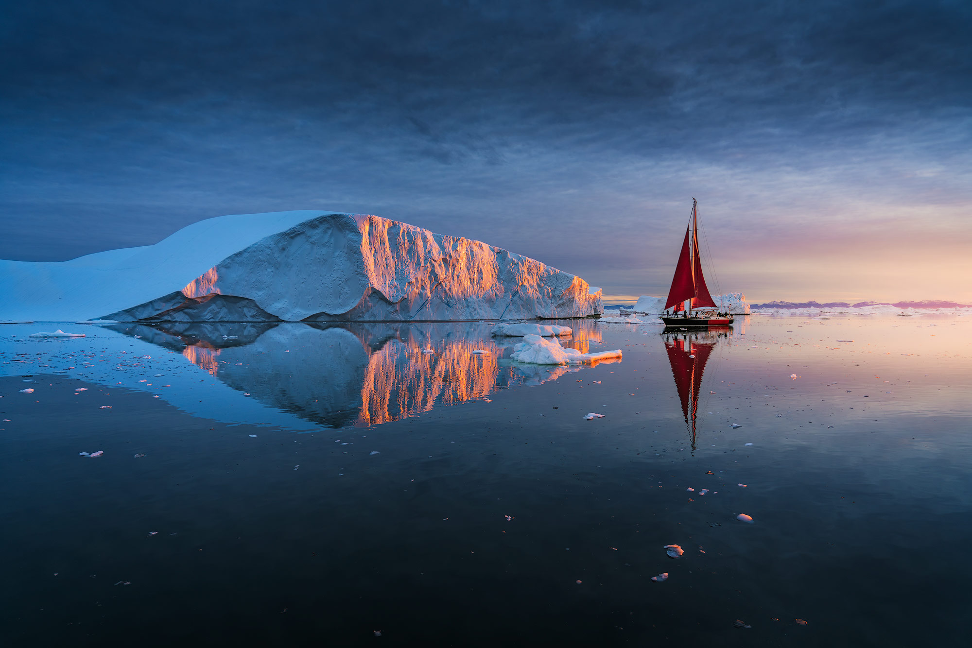 Icebergs and red sails