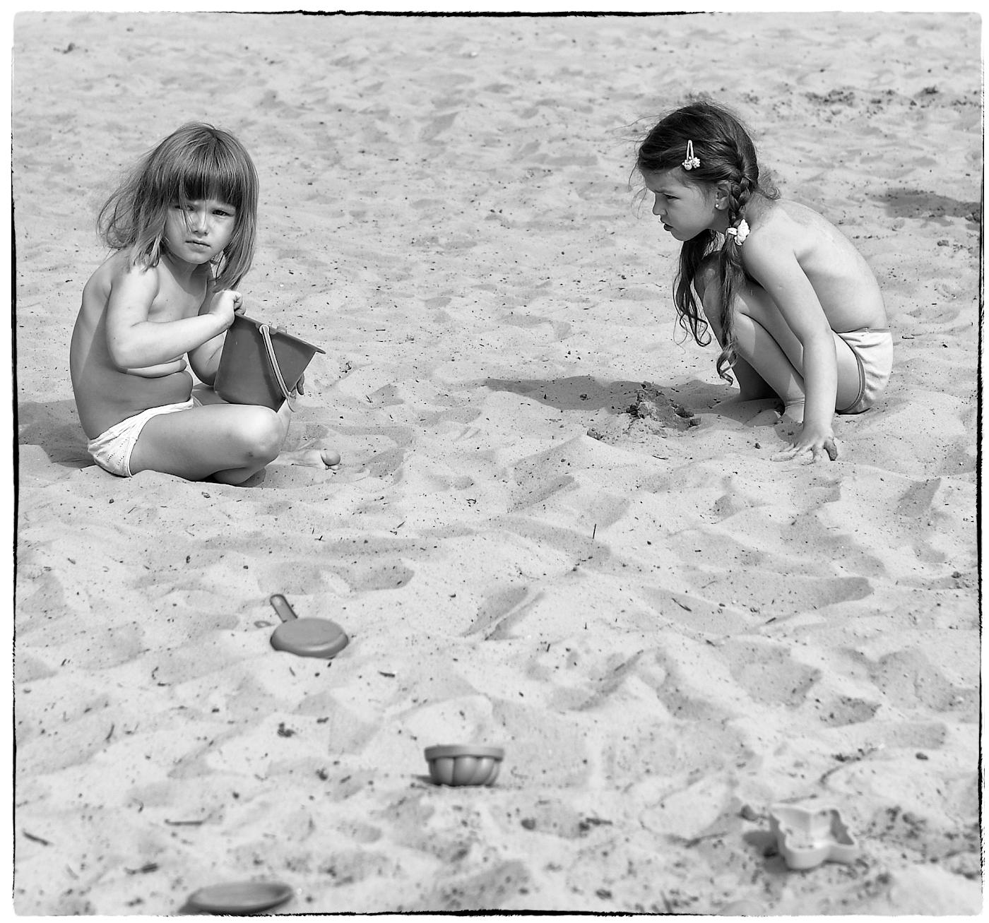 Two little girls in sandbox