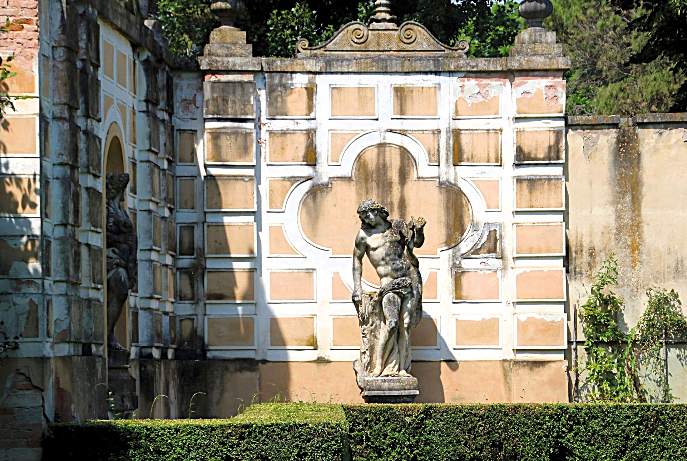 The statue beyond the hedge