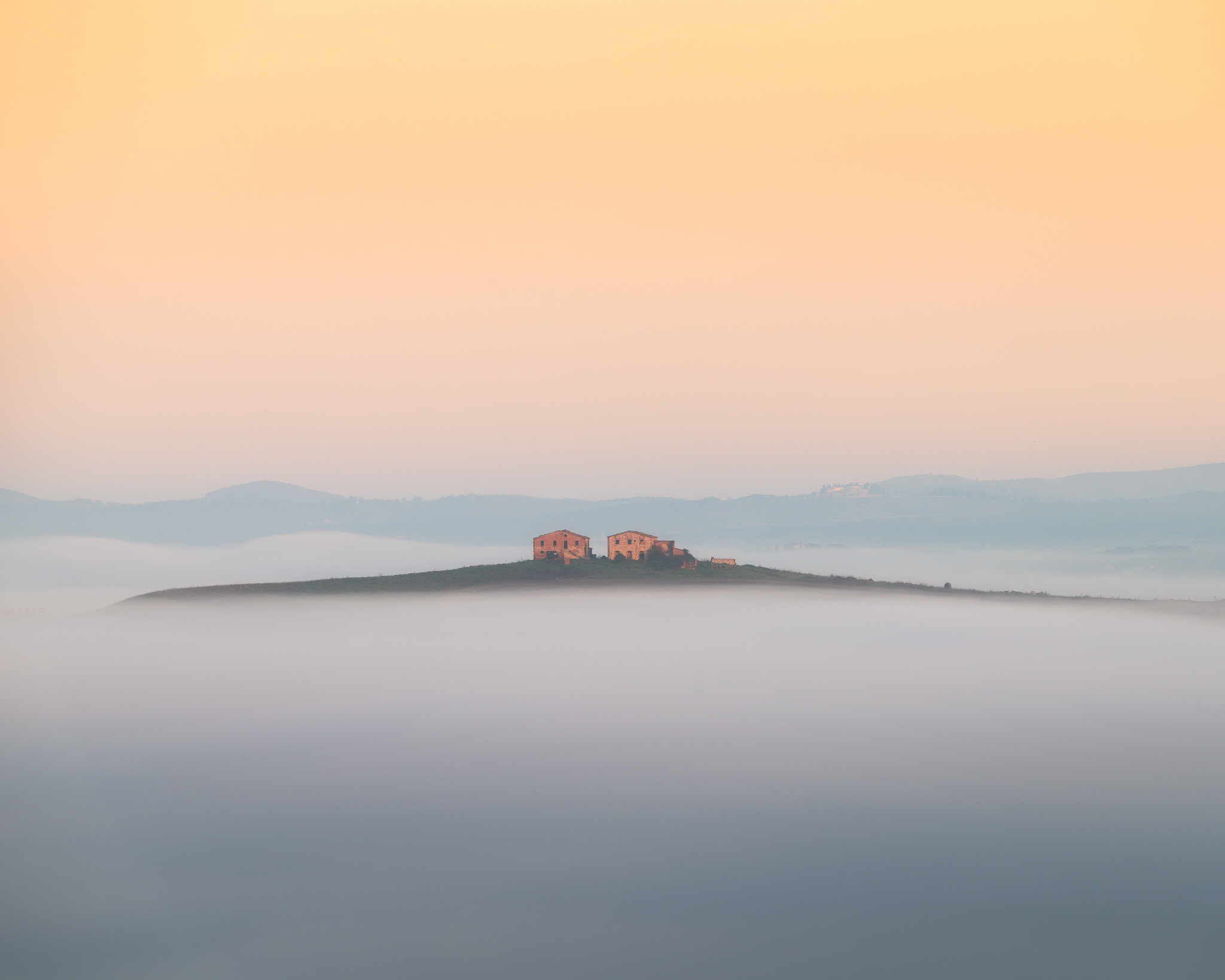 Twin cottages floating in the fog
