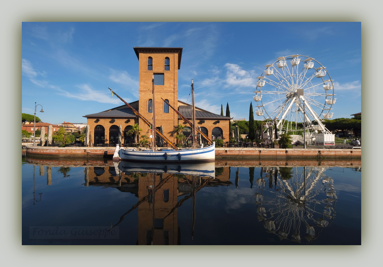Cervia.. Canal port with Ferris wheel