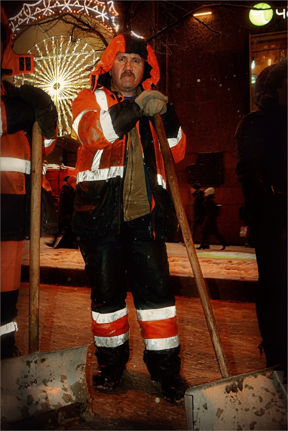 Street cleaning operator with snow shovel