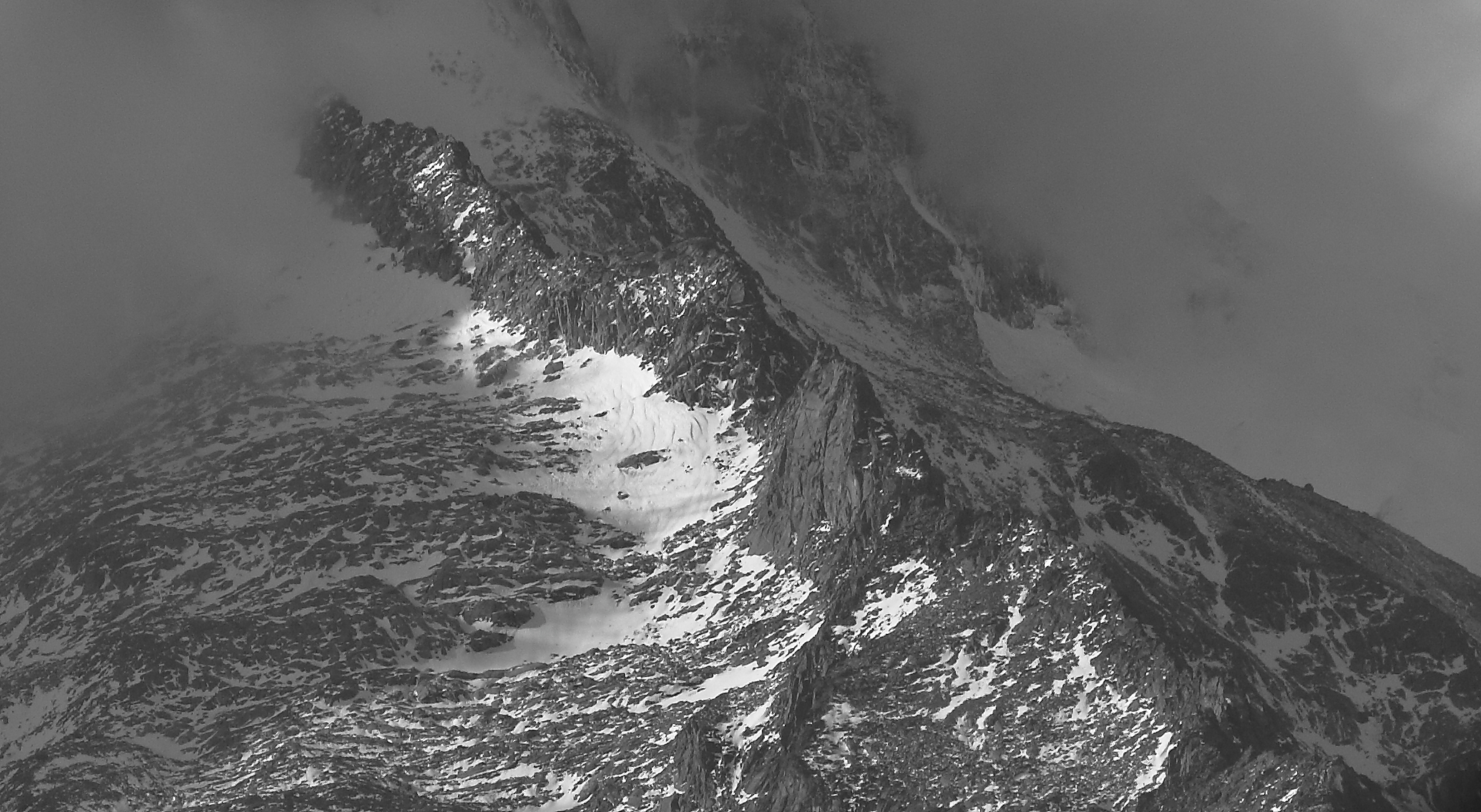 Clouds descending on the ridge. An avalanche of silence