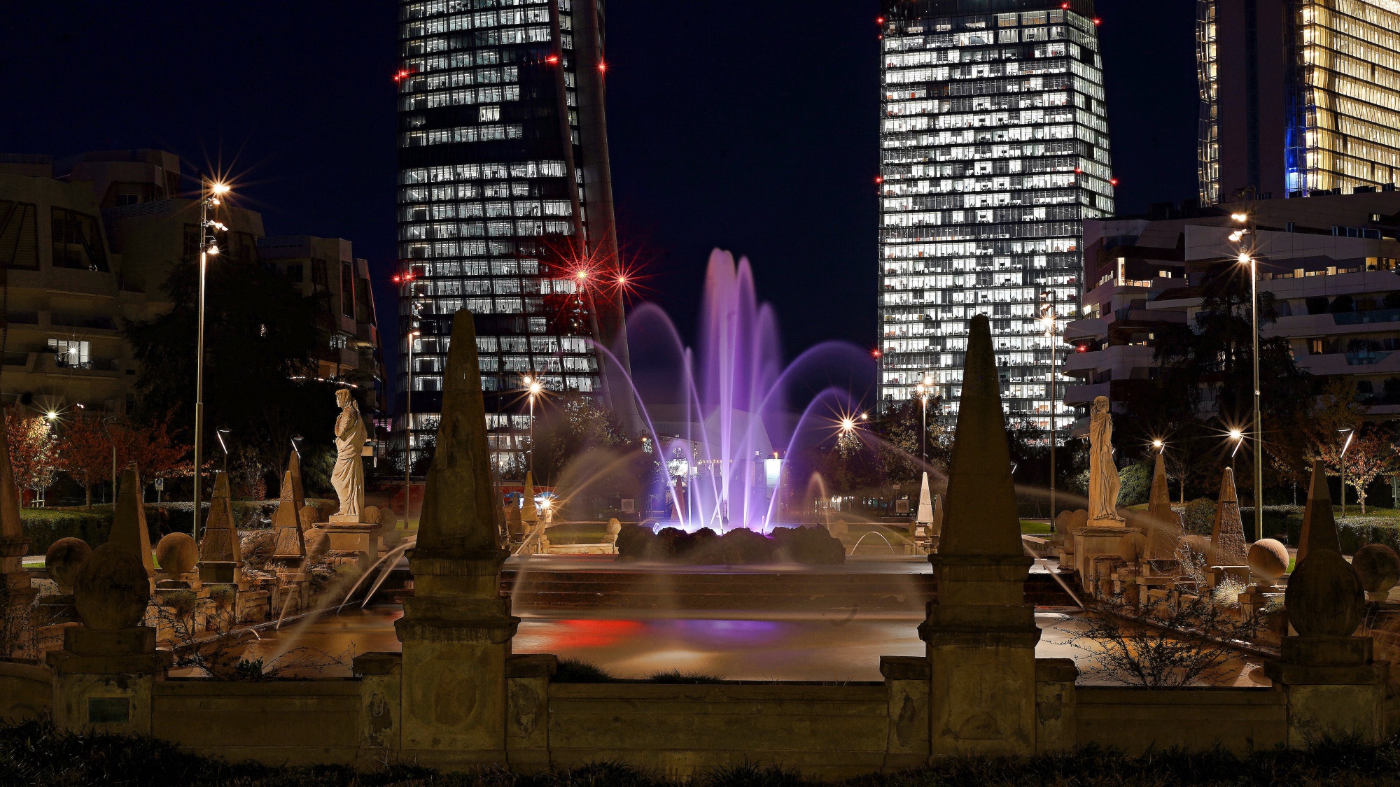 Fountain 4 seasons and background three towers Milan