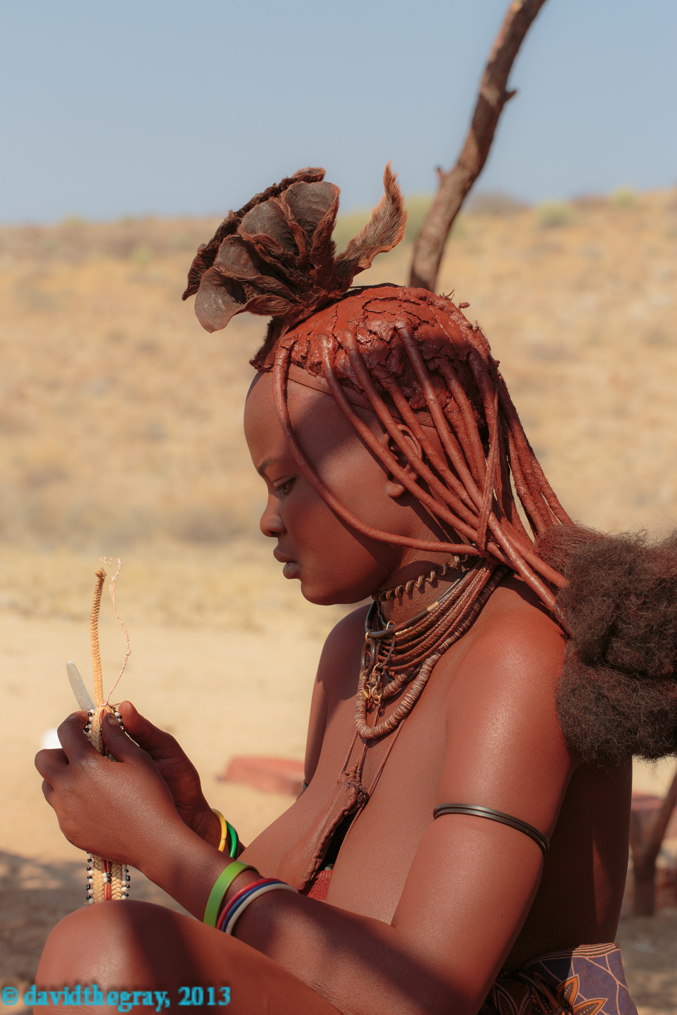 Himba girl at work