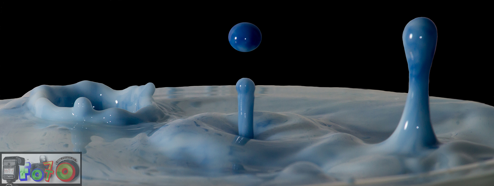 A triple splash of drops of colored milk