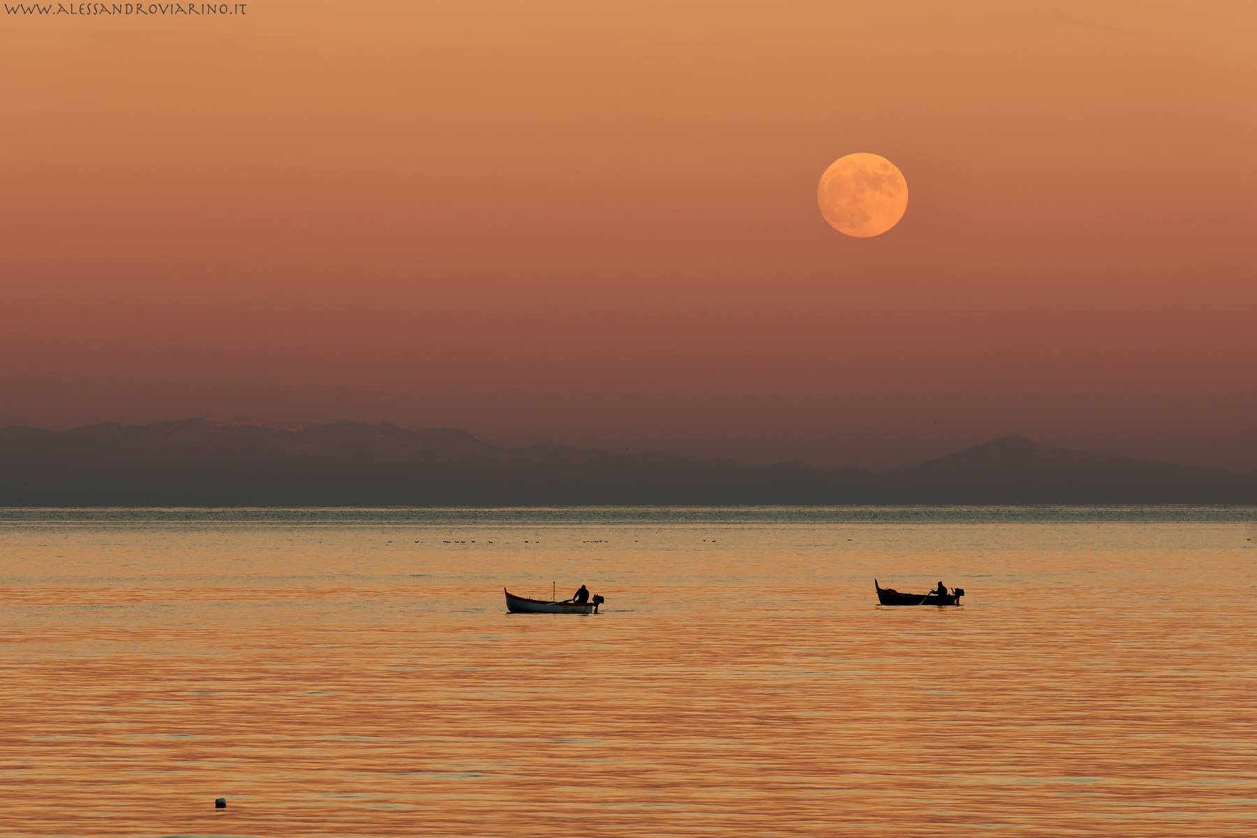 The moon rises over the Gulf of Alassio