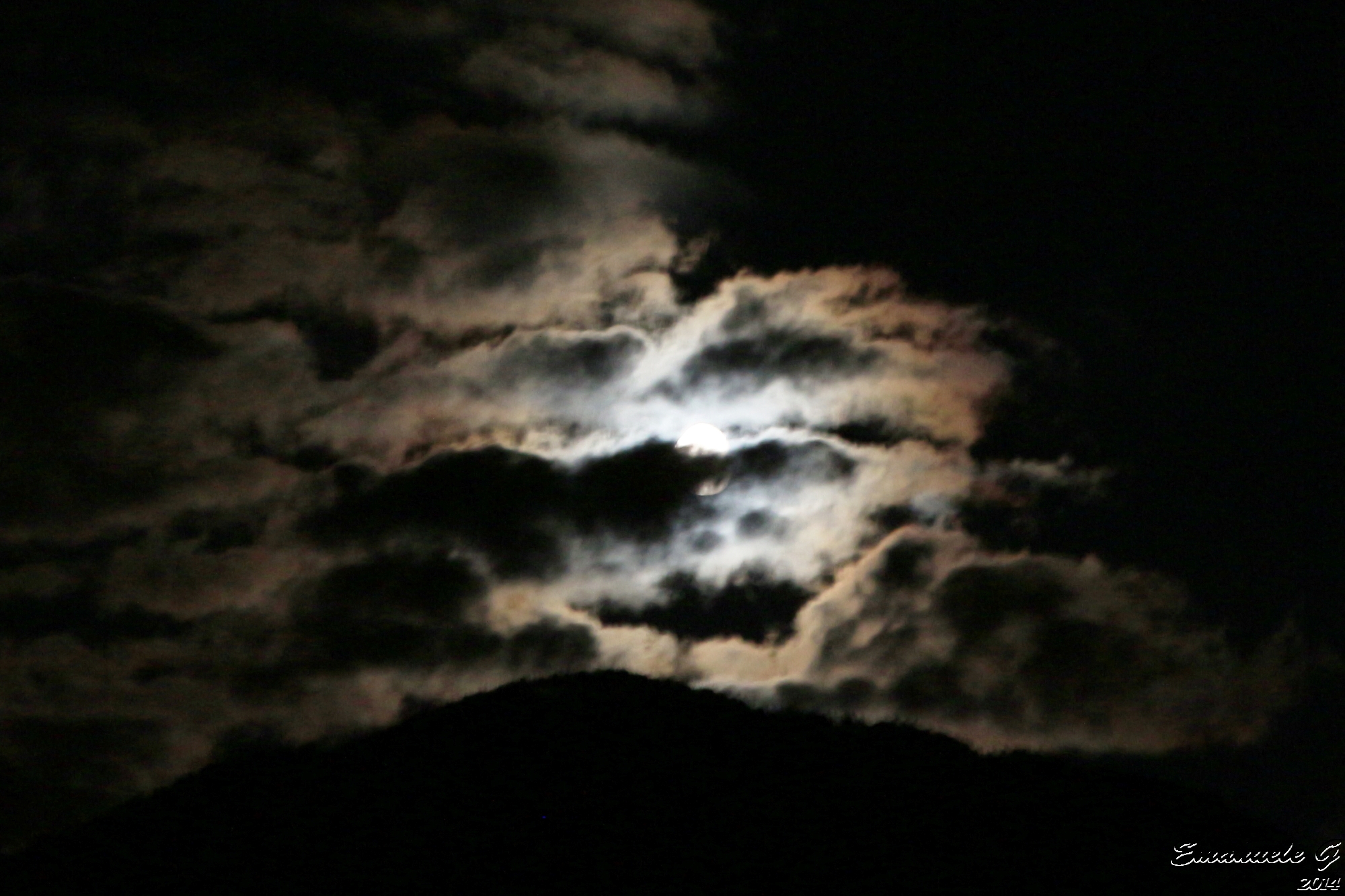 Moon between the clouds